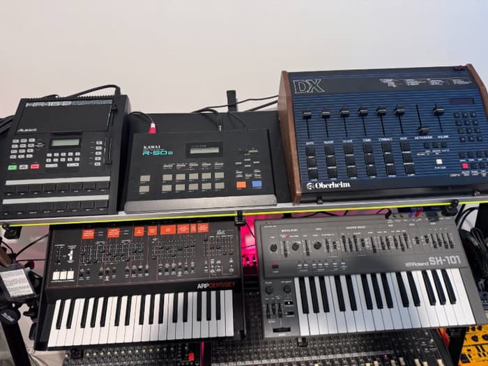 A close up of my drum machines -- Alesis HR16b, Kawai R-50 iii/e, and Oberheim DX -- and my Korg/ARP Odyssey and Roland SH-101.