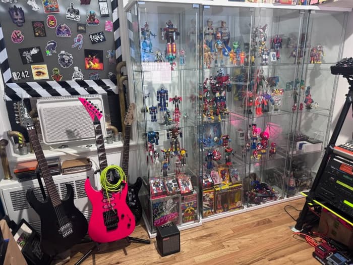 My collection of vintage Japanese toys next to a few of my guitars.